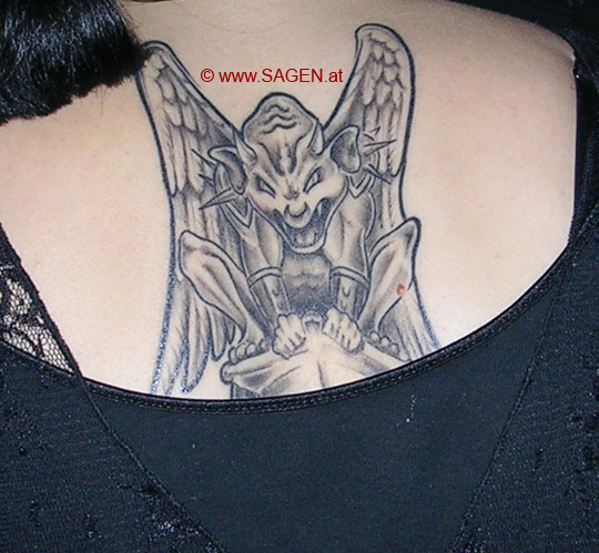Gargoyle tattooed on Laura's back. Laura put a large mirth greenman on her